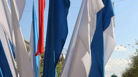 Russian flag fluttering in the wind. Material tricolor in the wind. Blue sky Stock Footage 108635542