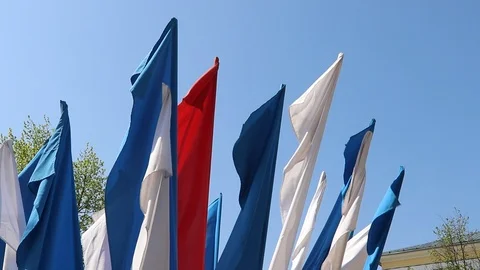 Russian flag fluttering in the wind. Material tricolor in the wind. Blue sky Stock Footage 108635614