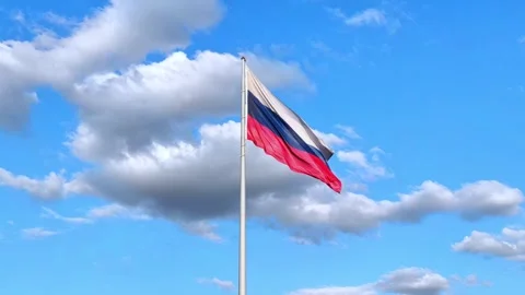 The Russian flag flutters in the wind against the blue sky. Stock Footage 278991393