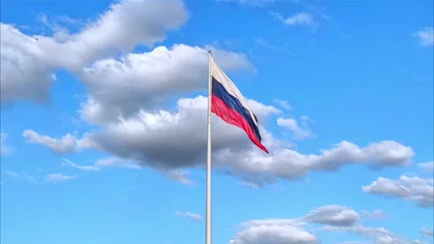 The Russian flag flutters in the wind against the blue sky. Video stock 279752773