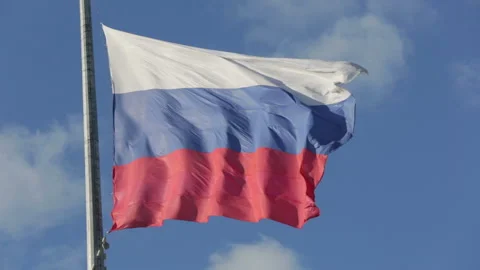 Russian flag flutters in the wind on the flagpole on blue sky background Stock Footage 94687002