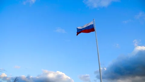 The Russian flag is flying against the blue sky Stock Footage 320996332