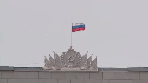 The Russian flag is lowered on the administration building of the Kirov Stock Footage 313439490