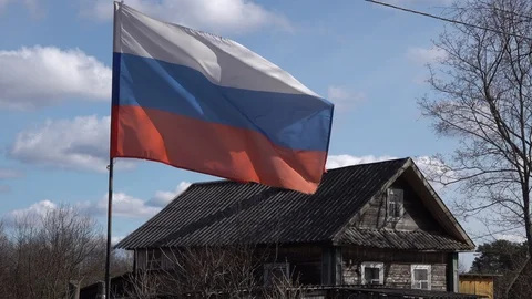Russian flag in russian village develops in the wind attached to a fishing rod 動画素材 129880621