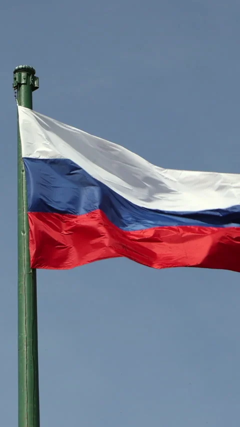Russian flag waving on flagpole against blue sky. Vertical Stock Footage 342934822