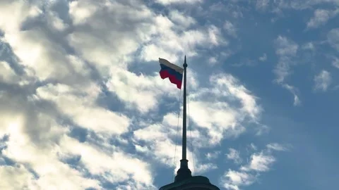 Russian flag waving on a pole against a cloudy blue sky. Video stock 333595480