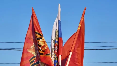 Russian flags waving under a clear blue sky in Moscow celebrating Victory Day Stock Footage 326447298