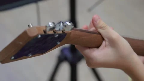 Russian folk instrument, balalaika, string instrument, close-up. Man playing Stock Footage 166385489