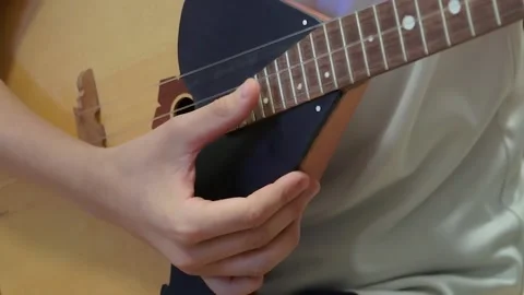 Russian folk instrument, balalaika, string instrument, close-up. Man playing Stock Footage 166385525