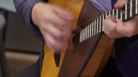 Russian folk instrument, balalaika, string instrument, close-up. Man playing Stock Footage 166385526