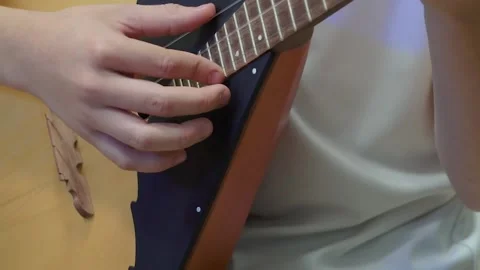 Russian folk instrument, balalaika, string instrument, close-up. Man playing Stock Footage 166385535