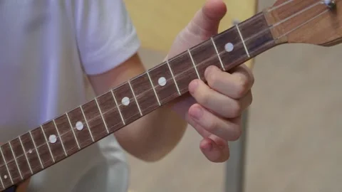 Russian folk instrument, balalaika, string instrument, close-up. Man playing Stock Footage 166385536