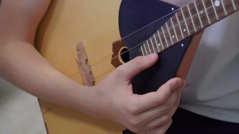Russian folk instrument, balalaika, string instrument, close-up. Man playing Stock Footage 166385537