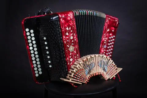 Russian folk instruments.Red bayan on a black background.Russian accordion Stock Photos