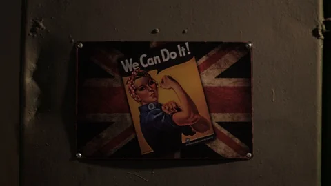 Russian hacker in the hat with earflaps speaks on the phone in the basement. A Stock Footage 107326576