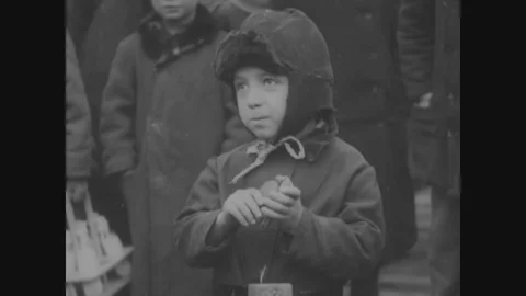 Russian kid eats a biscuit given by an American soldier - 1918-1919 Stock Footage 86476782