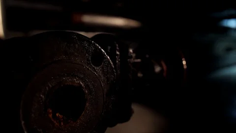 Russian man in a hat with earflaps, talking on the phone in a dark basement and Video stock 107324913