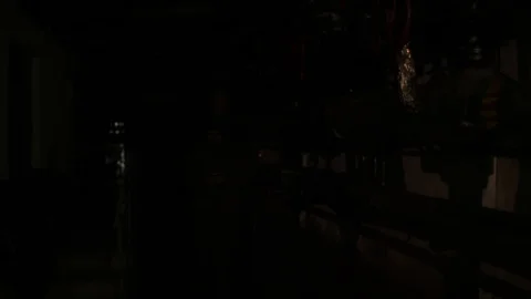 Russian man in a hat with earflaps, talking on the phone in a dark basement and Stock Footage 107325546