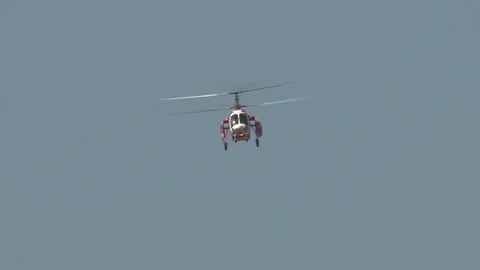 Russian multi-purpose helicopter Ka-226 of red color is climbing with rotation Stock Footage 205201192