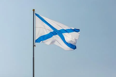 Russian Navy white flag with a blue saltire crosses a clear sky Stock Photos