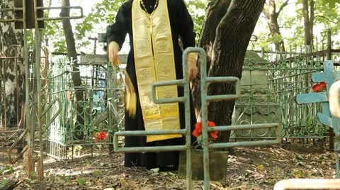 The Russian Orthodox Church. The priest is a prayer service at the cemetery. Stock Footage