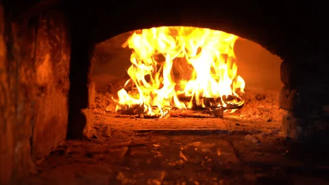 Russian oven, a fire in the fireplace Stockbeeldmateriaal 250549132