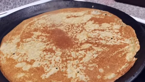 Russian pancake baking on griddle Stock Footage 163865360