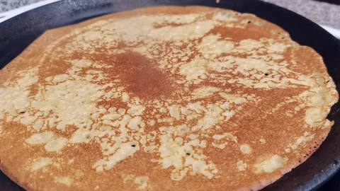 Russian pancake baking on griddle Video stock 163865406