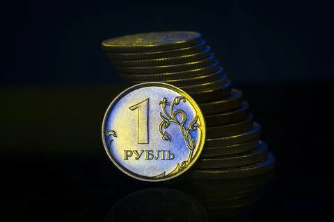 Russian Ruble Coins with falling Stack. Ukrainian flag colors illuminating. U Stock Photos