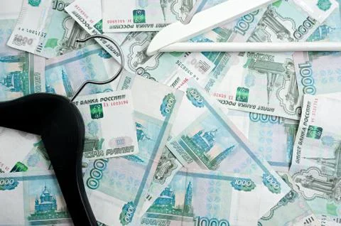 Russian rubles and empty clothes hangers in the wardrobe Foto stock