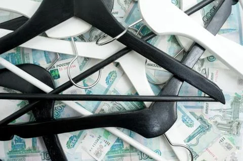 Russian rubles and empty clothes hangers in the wardrobe Stock Photos