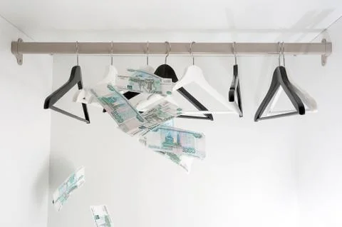 Russian rubles and empty clothes hangers in the wardrobe Stock Photos