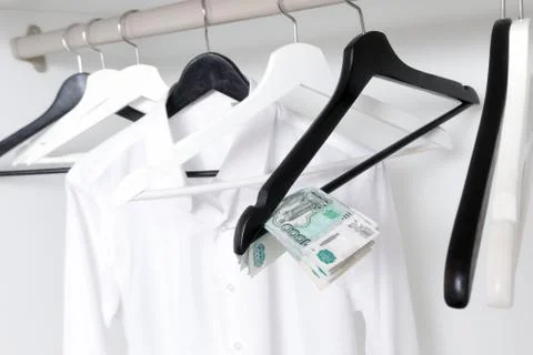 Russian rubles and empty clothes hangers in the wardrobe Stock Photos