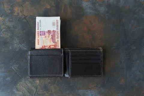 Russian rubles. Five thousandth notes stick out of the wallet. Stock Photos