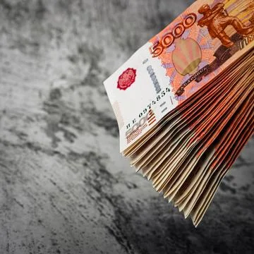 Russian rubles a large bundle on a gray background. A bundle of five-thousand Stock Photos
