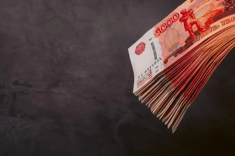 Russian rubles a large bundle on a gray background. A bundle of five-thousand Stock Photos