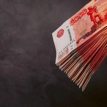 Russian rubles a large bundle on a gray background. A bundle of five-thousand Stock Photos