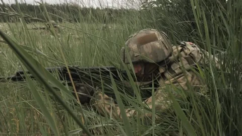 Russian soldiers with machine guns hide in the grass to attack Stock-Footage 218434163