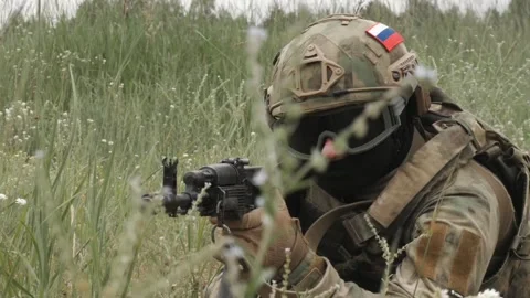 Russian soldiers with machine guns hide in the grass to attack Stock Footage 218434632