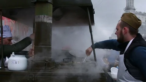 Russian soldiers work at the army kitchen on the celebration of Victory Day. Stock Footage 80633664