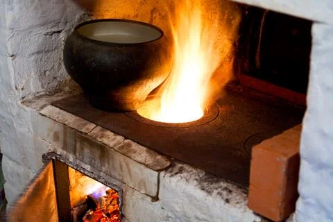 Russian stove and old cast-iron pot Stock Photos