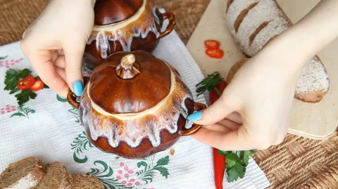 On the Russian table put a pot of food. Soup decorated with parsley. Stock Footage 61875066