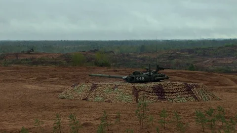 Russian tanks are driving through the field. Burst. Fires. Military equipment. Stock Footage 80991644