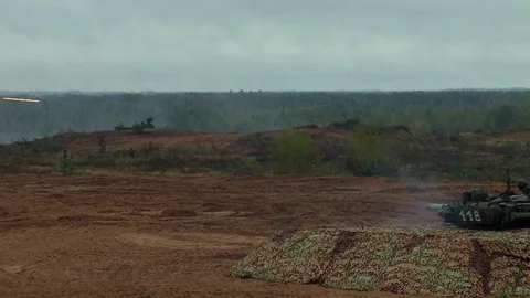 Russian tanks are driving through the field. Burst. Fires. Military equipment. Stock Footage 80991695