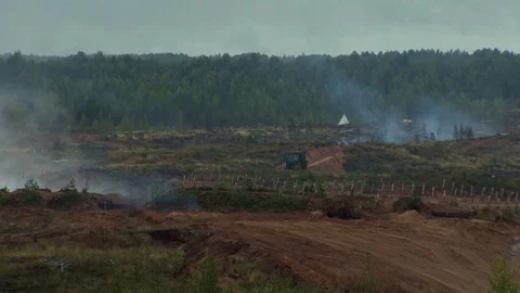 Russian tanks are driving through the field. Burst. Fires. Military equipment. Stock Footage 80991750