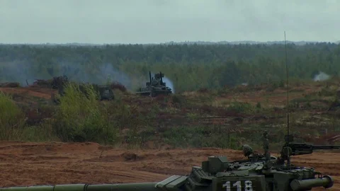 Russian tanks are driving through the field. Burst. Fires. Military equipment. Stock Footage 80991773