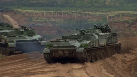 Russian tanks are driving through the field. Burst. Fires. Military equipment. Stock Footage 80991789