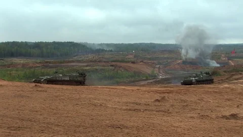 Russian tanks are driving through the field. Burst. Fires. Military equipment. Stock Footage 80991802
