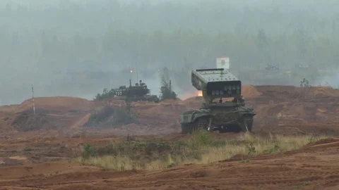 Russian tanks are driving through the field. Burst. Fires. Military equipment. Stock-Footage 80991881