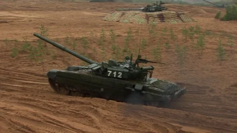 Russian tanks are driving through the field. Burst. Fires. Military equipment. Stock Footage 80991896
